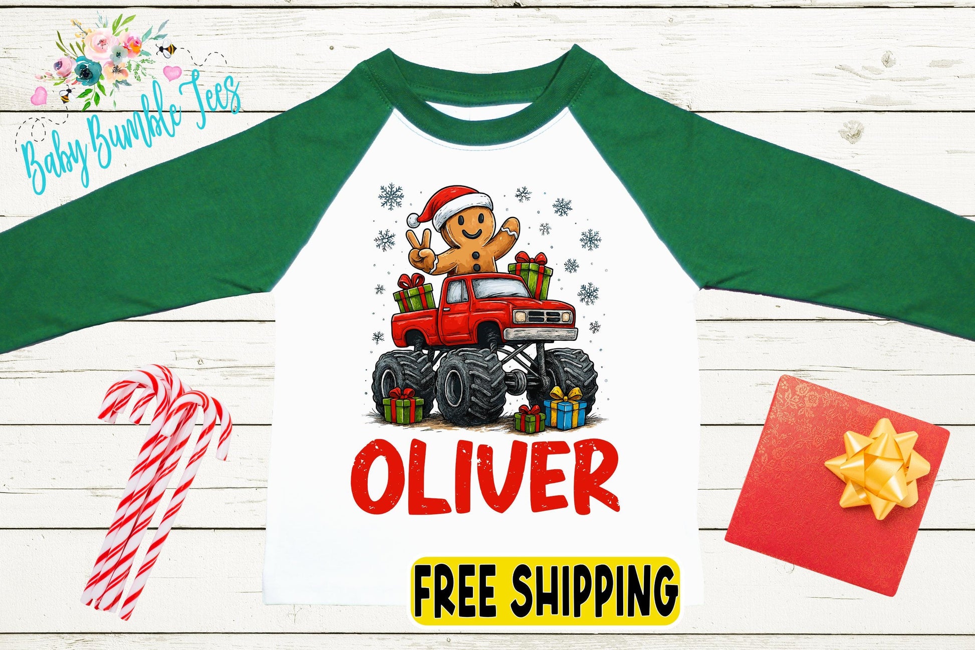 a white long-sleeve t-shirt with a graphic of a gingerbread man in a red truck, surrounded by presents and candy canes. The t-shirt has the name "Olivier" printed on it.