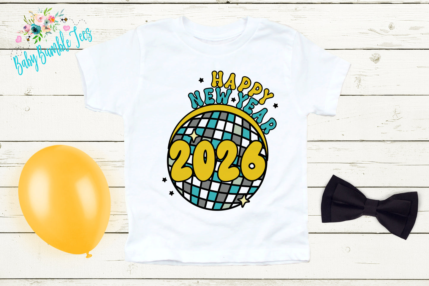 A white t-shirt with a graphic design featuring a disco ball and the text "Happy New Year 2026" printed on it, along with a yellow balloon and a black bow tie.