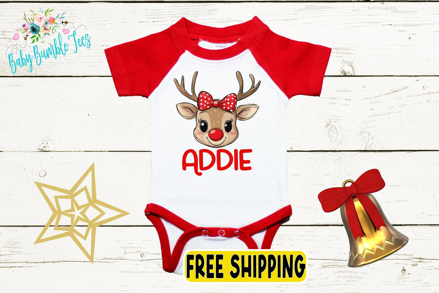 A red and white baby onesie with a cartoon reindeer and the name "Addie" printed on it, along with a bell and a star decoration.